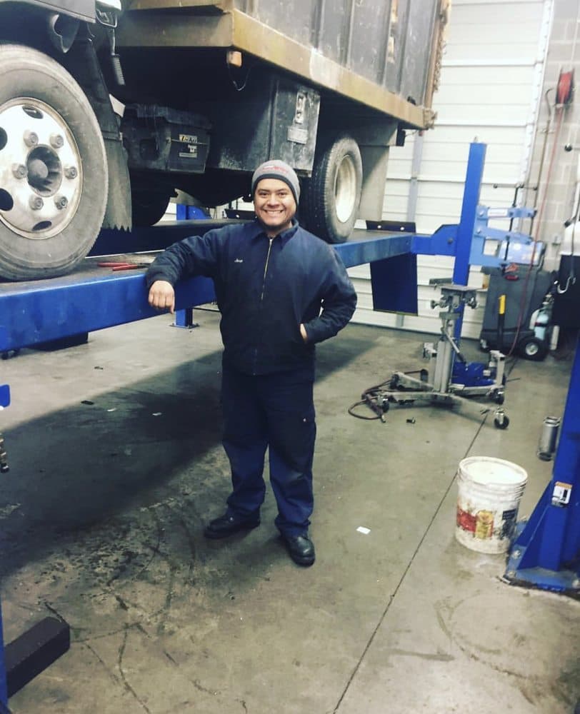 José Camacho smiling in his auto repair shop in Mount Vernon, WA